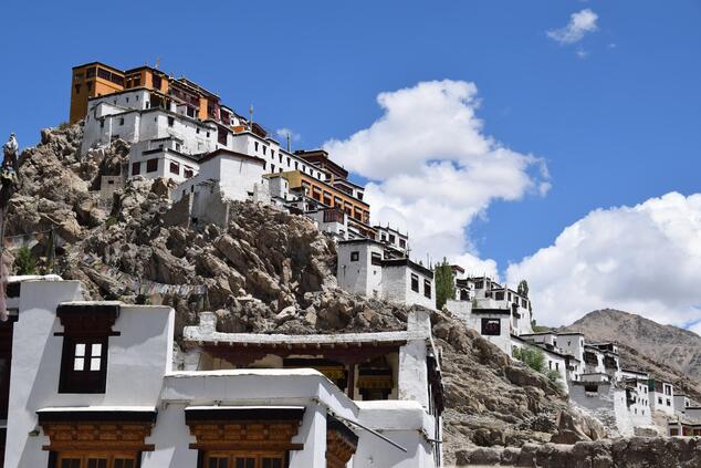 The monks live in small white houses at the foot of the monastery. travel luxury remote luxury ladakh india monastery thiksey