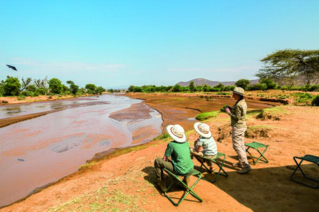 Waiting for animals to arrive at the river bank. family travel experience luxury adventure South Africa