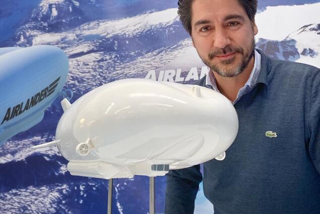 Gonzalo Gimeno, OceanSky ambassador, next to a model of the Airlander10 airship. sustainable aviation airship oceanSky