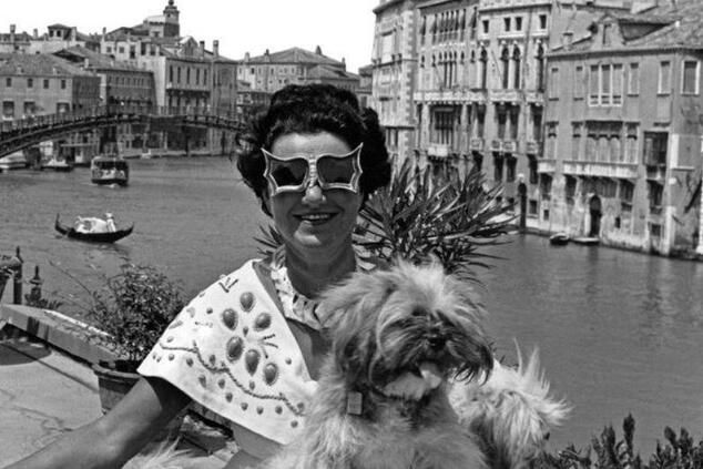 Peggy Guggenheim at the Grand Canal entrance of her Venetian palazzo with one of her dogs. peggy guggenheim