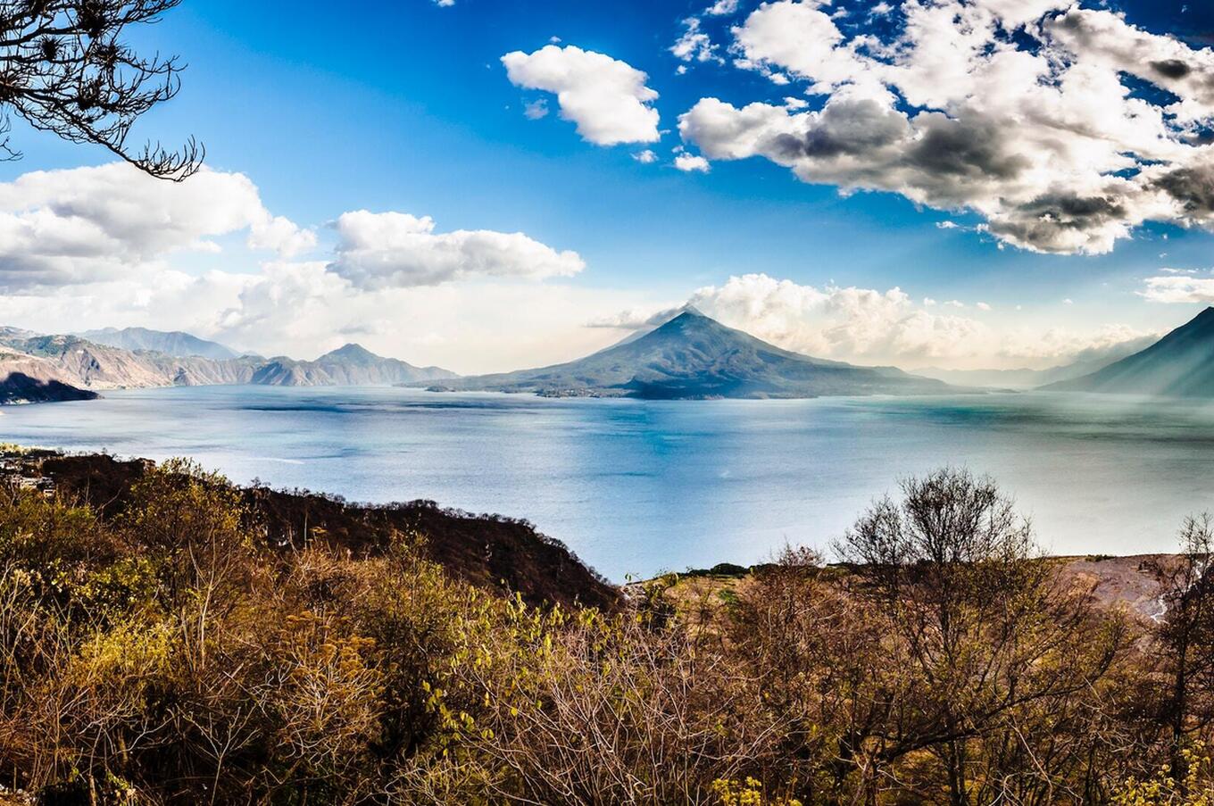 The three volcanoes of Lake Atitlan: San Pedro, Toliman and Atitlan. Photo by Alexander Schimmeck on Unsplash.